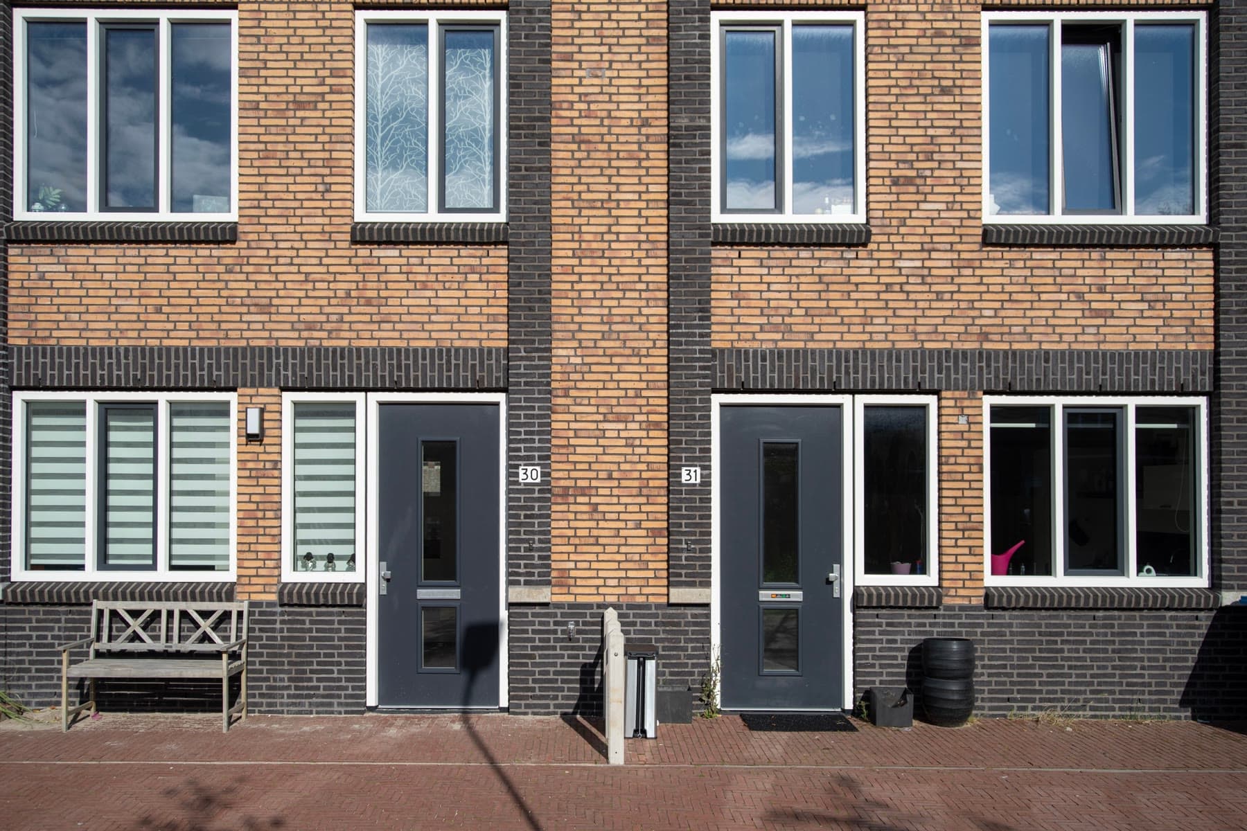 Dutch terraced houses with brick facades along a residential street